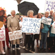 Activists who want Congress to increase pancake-cure funding march
in front of a bus depot in Bellingham, WA.